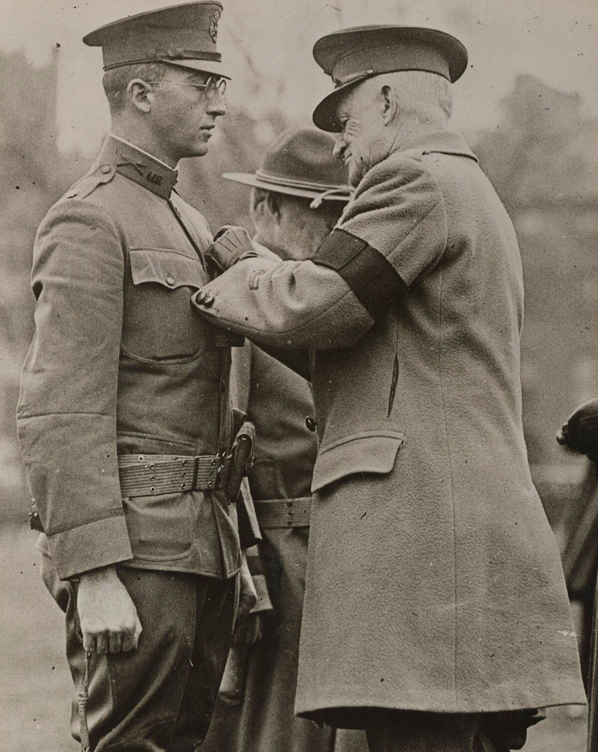 Maj. Gen. Clarence R. Edwards pinning the Medal of Honor on Lt. Col. Charles W. Whittlesey on Boston Common. (Public Domain)