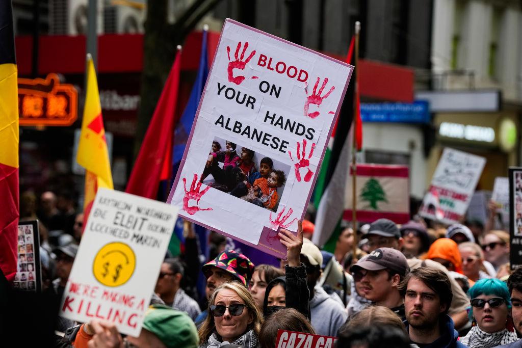 A placard is held by a protester referencing Australian Prime Minister Anthony Albanese in Melbourne, Australia, on Oct. 6, 2024. (Asanka Ratnayake/Getty Images)