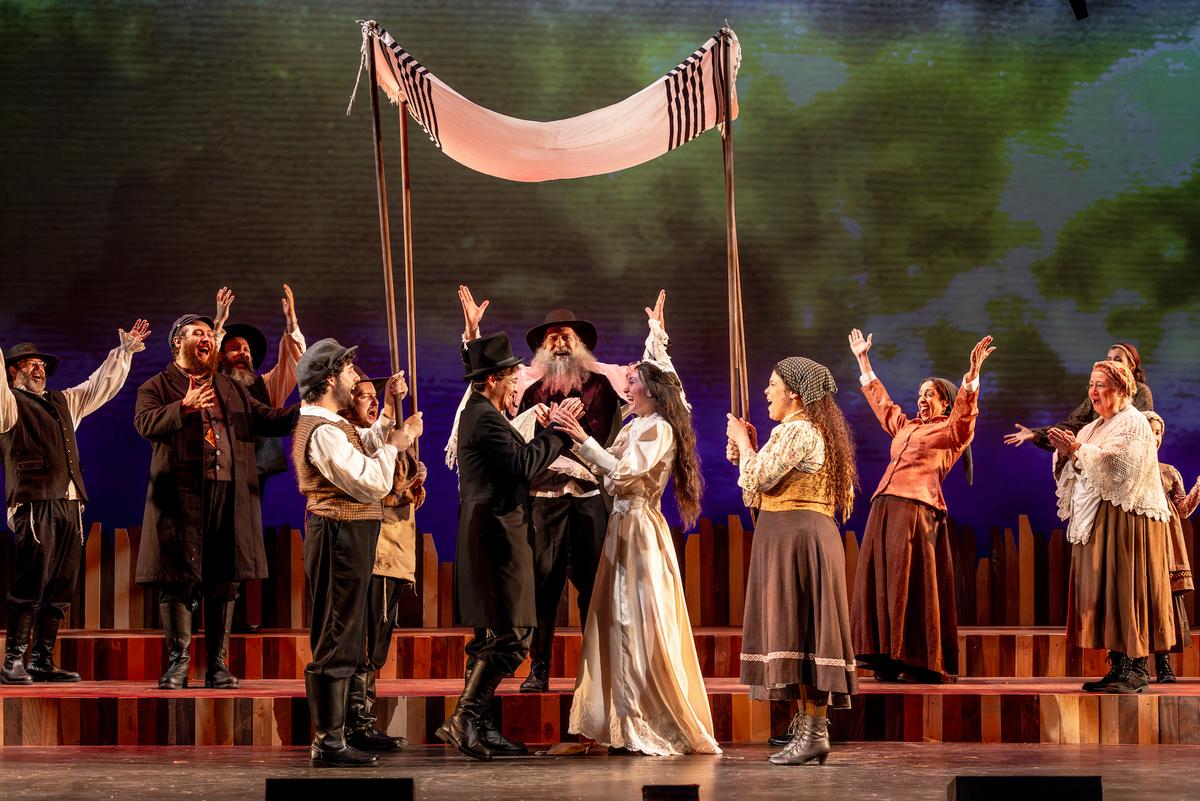 The bride Tzeitel (Madison Uphoff) ends up with Motel (Nathan Kabara) the tailor, celebrated in their traditional wedding, in "The Fiddler on the Roof" full circle. (Brett Beiner)