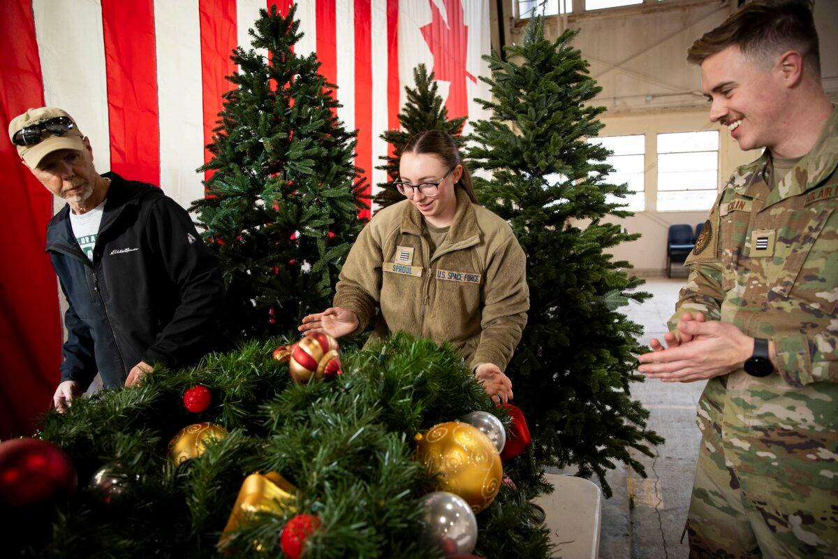 Personnel and volunteer reserve officers set up the NORAD Tracks Santa Operations Center in a spare hangar at Peterson Space Force Base, Colo., in December 2023. (Public Domain)