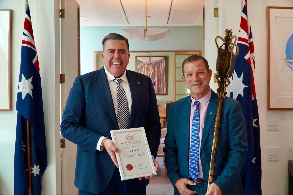Milton Dick and David Batt stand with a replica mace and a certificate of authenticity. (Courtesy of David Batt)