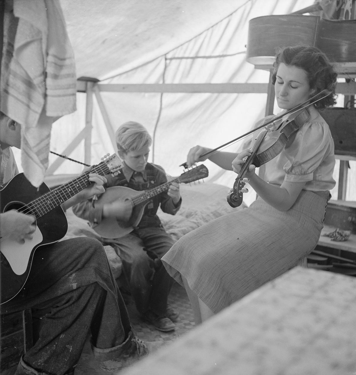 A migrant family from Arkansas playing "hillbilly" songs in California, 1939. Library of Congress. (Public Domain)