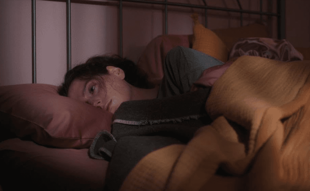 Agnes (Eva Victor) is having a difficult time sleeping, in "Sorry, Baby." (A24)