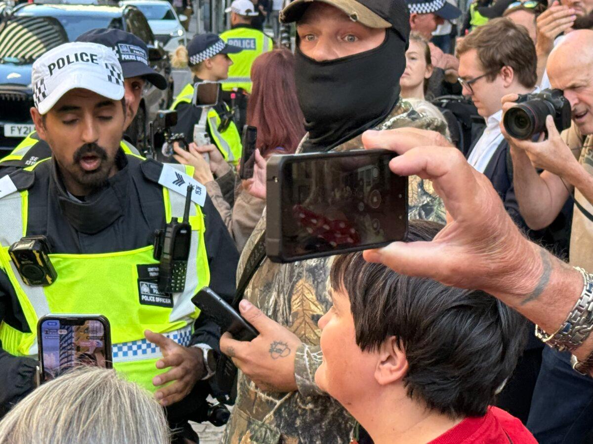 Protesters and police officers outside Britannia Hotel in Canary Wharf, east London, on Aug. 8, 2025. (Evgenia Filimianova/The Epoch Times)