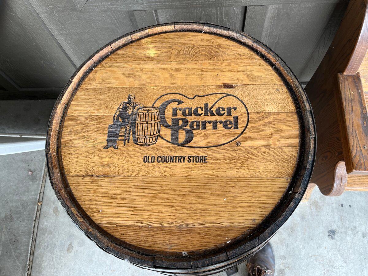 'Old Timer' Uncle Herschel is featured on a wooden barrel outside the Cracker Barrel Old Country Store in Gallup, N.M., on Aug. 28, 2025. (Allan Stein/The Epoch Times)