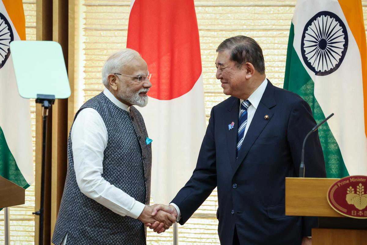 Indian Prime Minister Narendra Modi (L) and Japanese Prime Minister Shigeru Ishiba shake hands during a joint press conference in Tokyo on Aug. 29, 2025. (Takashi Aoyama/Pool/AFP via Getty Images)