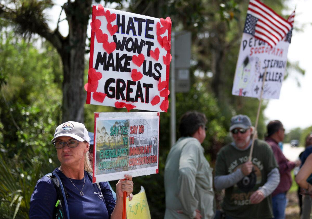 A protester stands outside the migrant detention facility dubbed “Alligator Alcatraz” at the Dade-Collier Training and Transition Facility in Ochopee, Fla., on July 12, 2025. (AP Photo/Alexandra Rodriguez)
