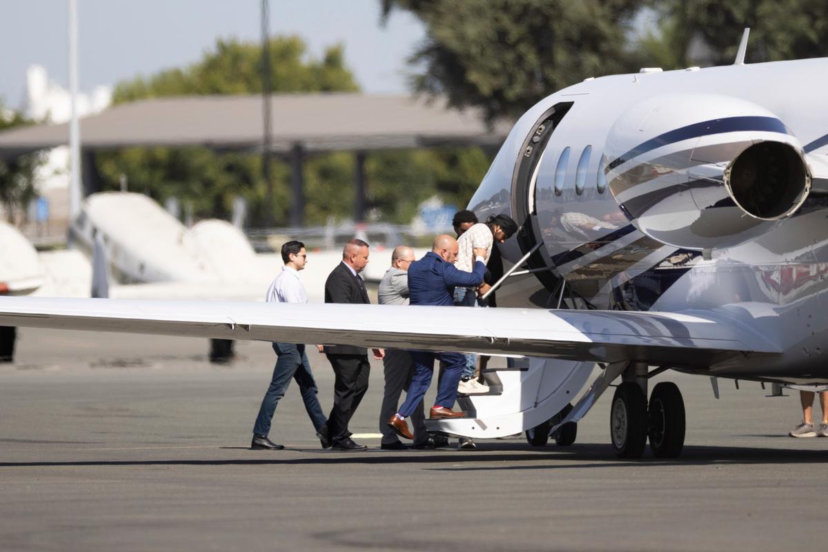 Harjinder Singh is escorted to an airplane by Florida Lt. Gov. Jay Collins and law enforcement in Stockton, Calif., on Aug. 21, 2025. Singh is facing several charges after his transport was involved in a fatal collision in Florida. He is also accused of illegally entering the United States in 2022. (AP Photo/Benjamin Fanjoy)