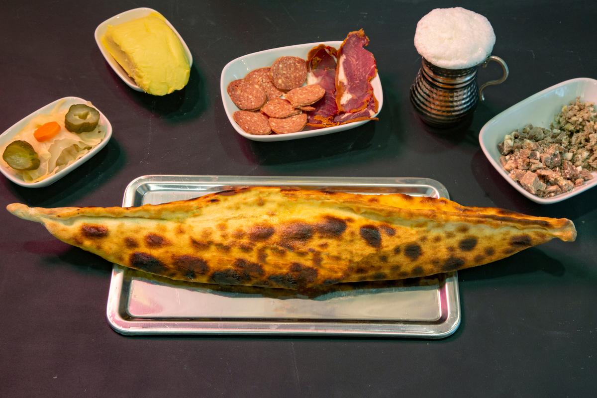 This boat-shaped flatbread is filled with bubbling cheese and butter, offering a satisfying bite. (M Ali Unal/Shutterstock)