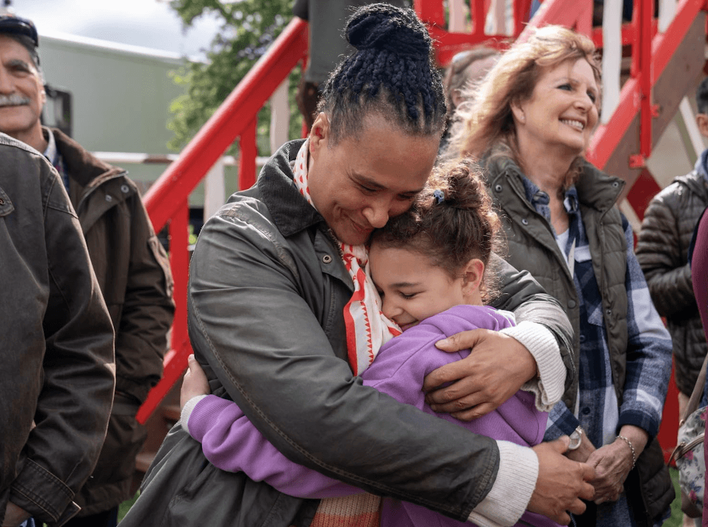Aunt Dinah Little (Golda Rosheuvel) hugs her niece Charlie (Priya-Rose Brookwell), in "Grow." (Sky Cinema/Pumpkin Films)