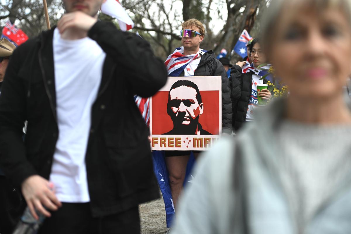 A man holds a placard with an image of fugitive Dezi Freeman at a protest against government immigration policy, during a march from Rundle Park in Adelaide, Australia on Aug. 31, 2025. (Tracey Nearmy/Getty Images)