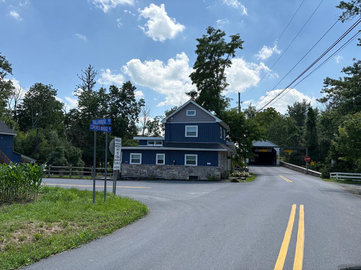 Covered Bridge Road directs visitors to this historical intersection, which is home to an old tollhouse and a white wooden covered bridge. (Deena Bouknight)
