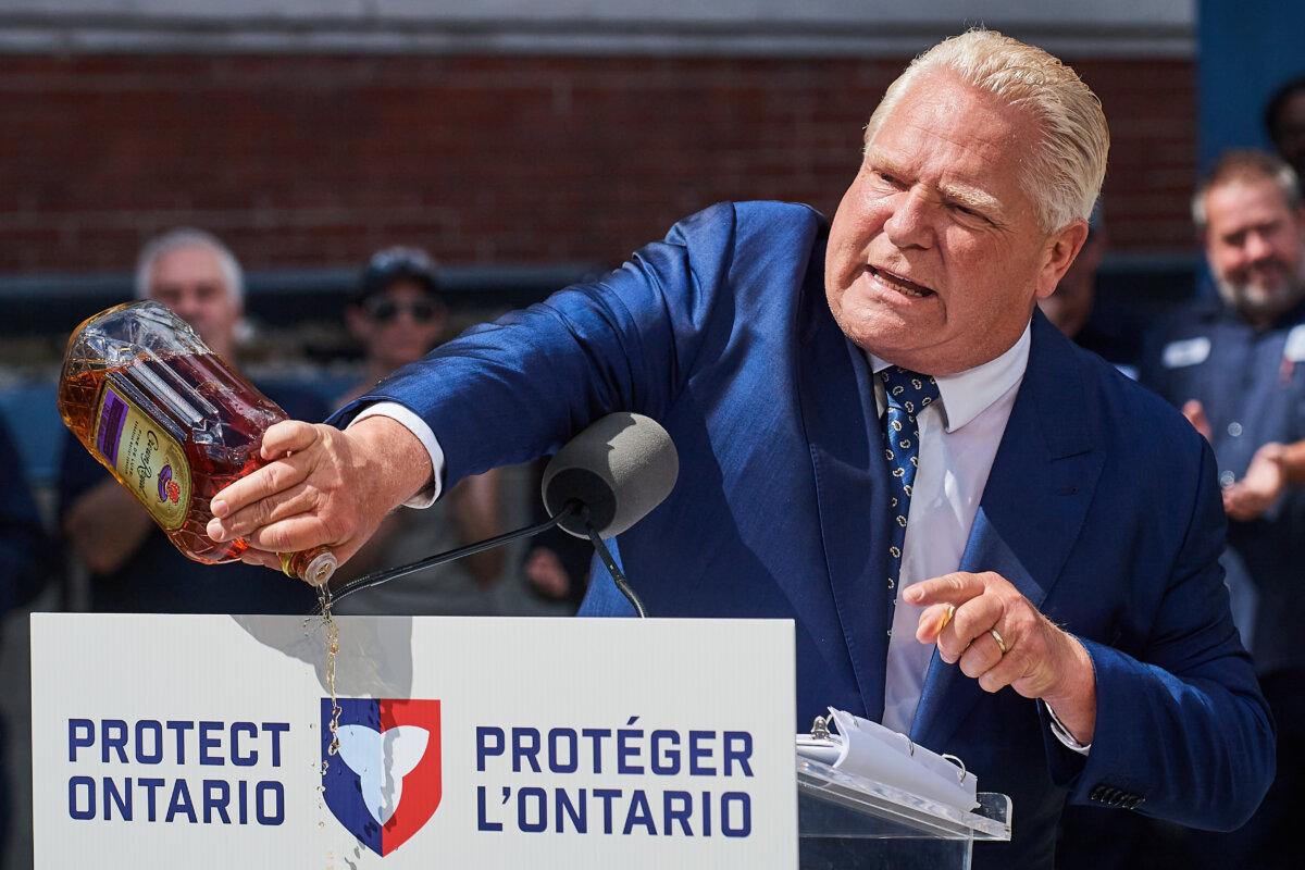Ontario Premier Doug Ford empties a Crown Royal bottle of whisky at a press conference in Kitchener, Ont., on Sept. 2, 2025. (The Canadian Press/Sammy Kogan)