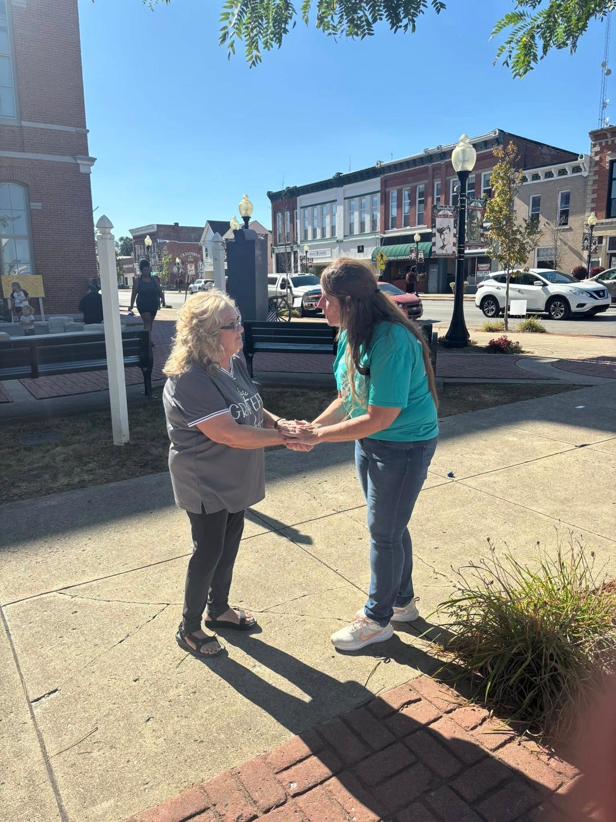 Beverly Aikins is greeted by Kim Davis after speaking at an addiction recovery event in Greenfield, Ohio, on Aug. 30, 2025. (Jeff Louderback/The Epoch Times)