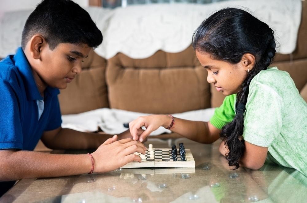 Indian children play chess at home and in school. (<a href="https://www.shutterstock.com/g/StockImageFactory">StockImageFactory.com</a>/<a href="https://www.shutterstock.com/image-photo/happy-indian-asian-multigenerational-family-six-1915147717">Shutterstock</a>)