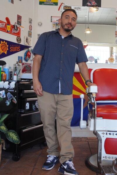 Jonathan Tafoya stands inside Fonzy's Barbershop, in the Nob Hill section of Albuquerque, N.M., on Sept. 3, 2025. (Allan Stein/The Epoch Times)