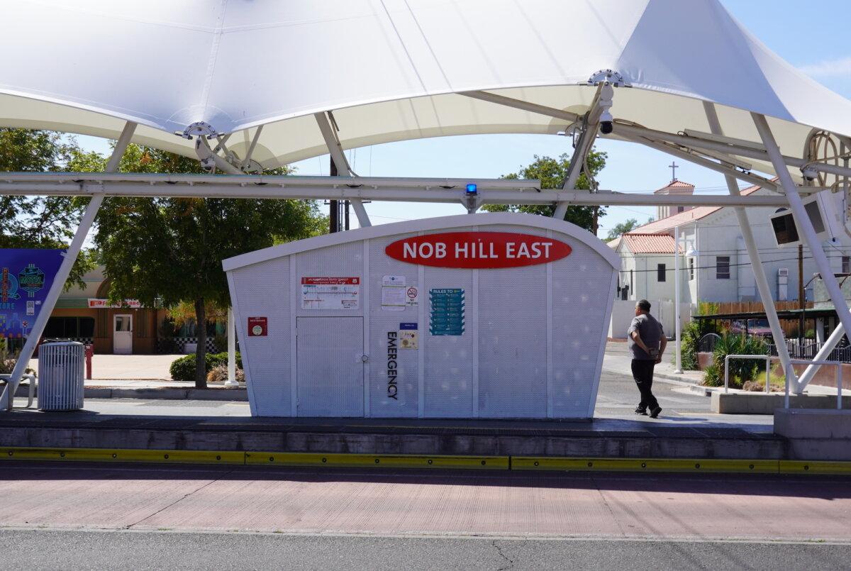A man waits for public transportation to arrive in Albuquerque's Nob Hill East section on Sept. 3, 2025. (Allan Stein/The Epoch Times)