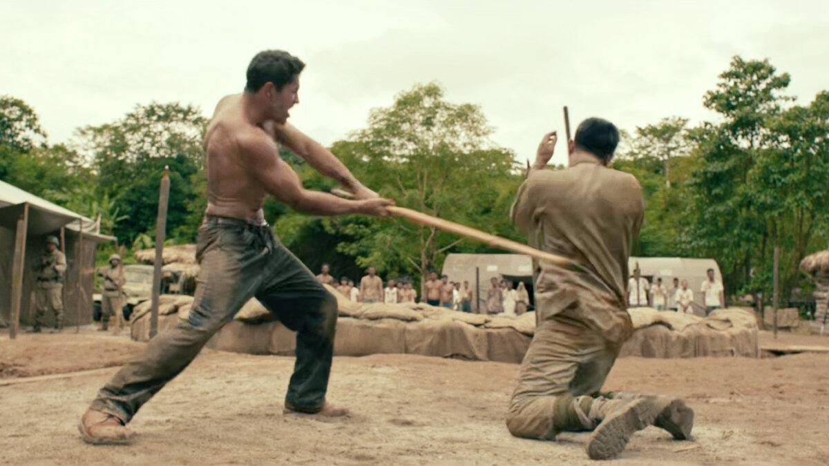 Wing Commander James Wright (Scott Adkins, L) faces guards, in "Prisoner of War." (Well Go USA)
