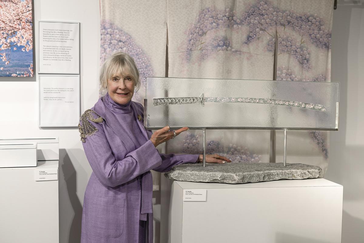 Duggan points to “Life Is Fleeting,” fashioned out of fused, etched, and polished glass, and created by TC Studio. (Adhiraj Chakrabarti)