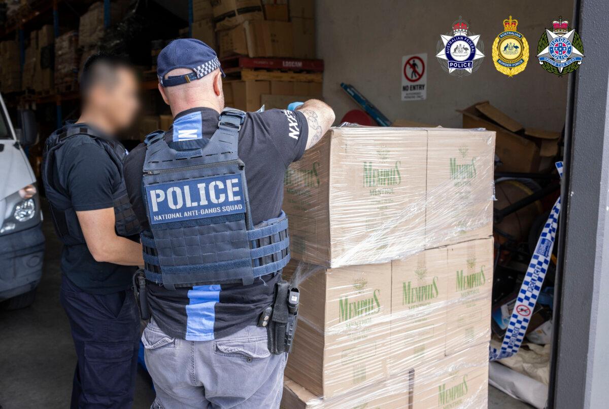 Police examine some of the illegal tobacco products seized in raids across commercial and residential properties in Melbourne, Australia, on Sept. 9, 2025. The seized items included over five million cigarettes, 5,000 vapes and 7 tonnes of loose-leaf tobacco, all imported by one criminal gang. (Courtesy of Australian Federal Police)