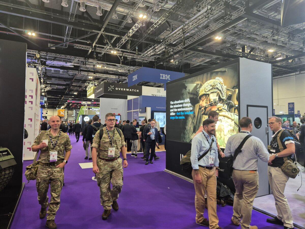 Two British Army officers walk past a display in the Tech Zone at the DSEI exhibition at Excel in London on Sept. 10, 2025. (Chris Summers/The Epoch Times)