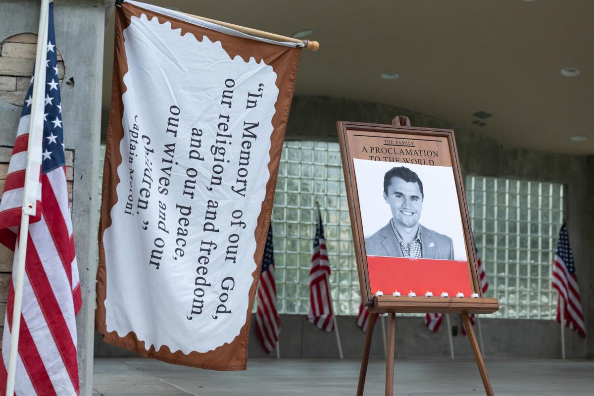Candles are left in front of a photo of conservative influencer Charlie Kirk as people attend a vigil in Orem City Center Park, Orem, Utah, on Sept. 10, 2025. (Melissa Majchrzak/AFP via Getty Images)