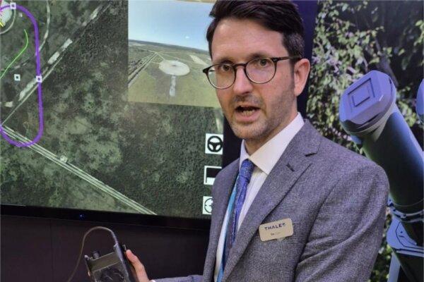 A Thales UK product manager, who can be referred to only as Tim for security reasons, shows off the Storm 2 drone jamming device at DSEI at the ExCel center in London on Sept. 10, 2025. (Chris Summers/The Epoch Times)