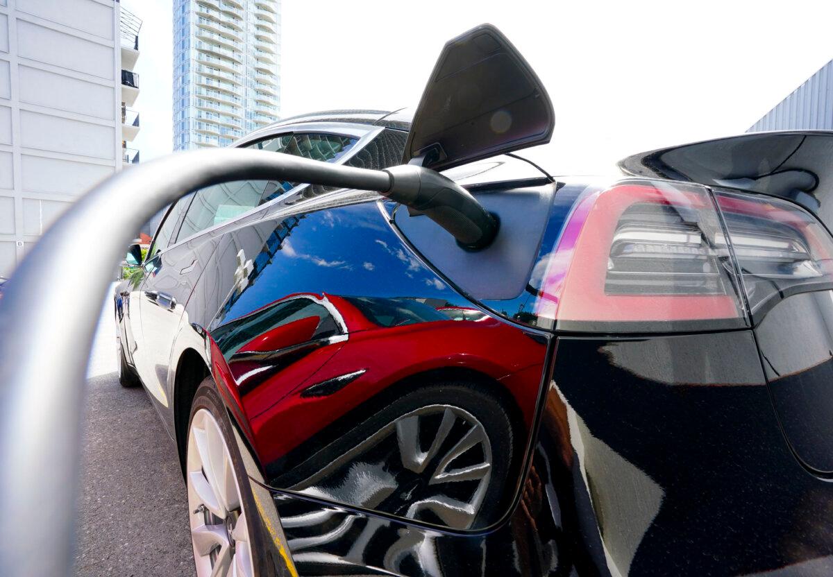 An electric vehicle is seen being charged in Ottawa in a file photo. (The Canadian Press/Sean Kilpatrick)