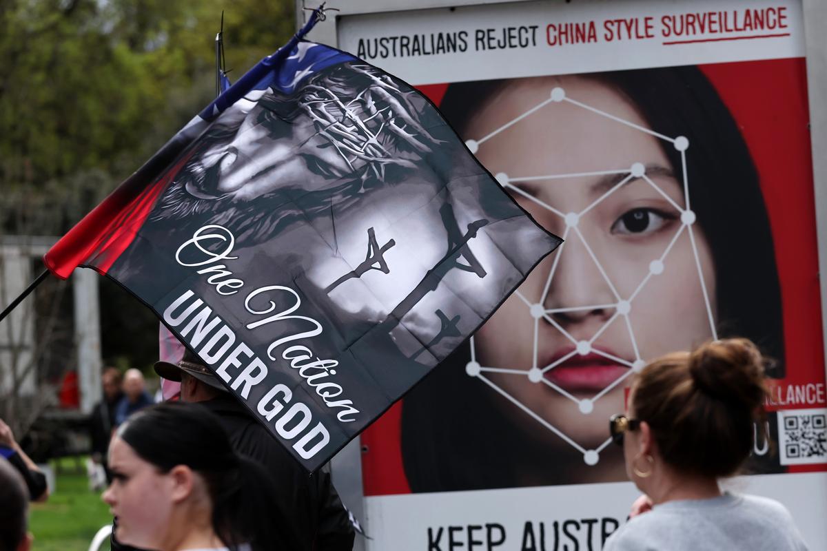 Protestors holding banners against Chinese Communist Party surveillance and supporting traditional Australian values in Melbourne, Australia on Sept. 13, 2025. (AAP Image/Con Chronis)