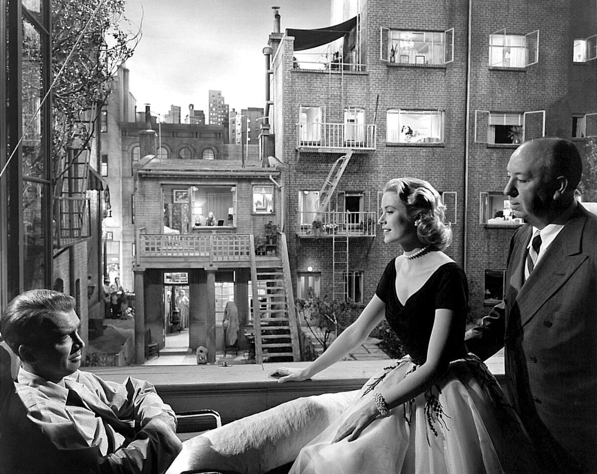 (L–R) Actors James Stewart and Grace Kelly and director Alfred Hitchcock on the set of “Rear Window.” (Paramount Pictures/MovieStillsDB)