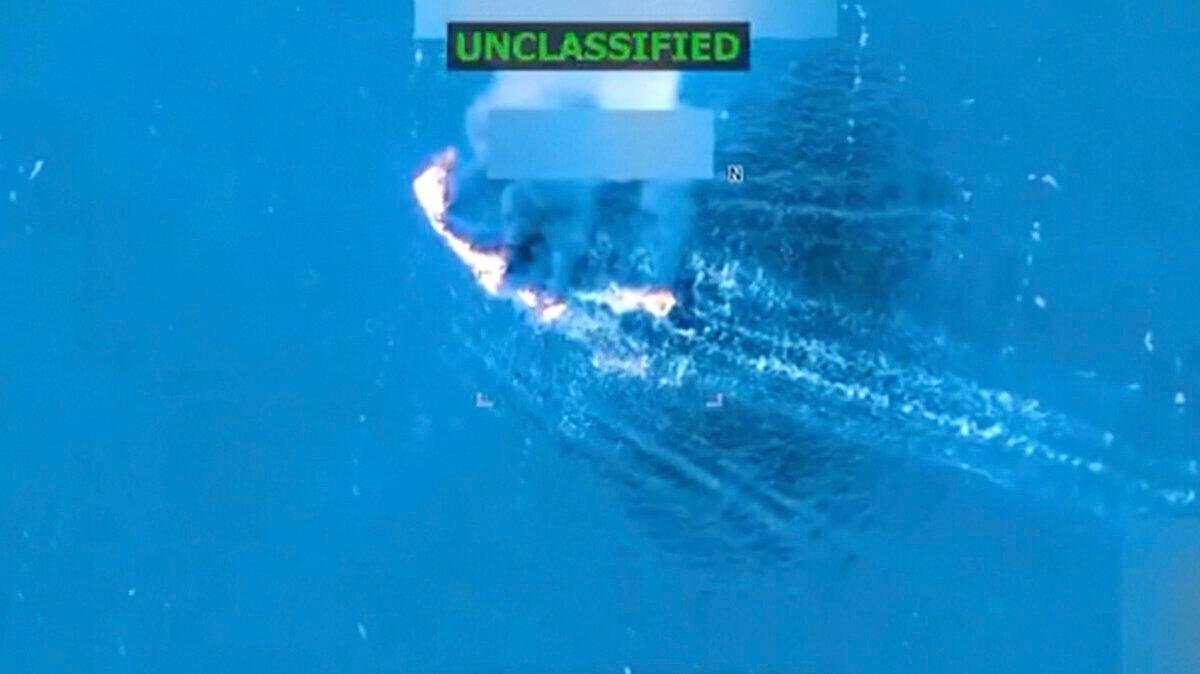 An alleged drug cartel vessel burns following a U.S. military strike, the third such strike carried out against a suspected drug boat in recent weeks, in a still from video released on Sept. 19, 2025. (President Donald Trump via Truth Social via Reuters)