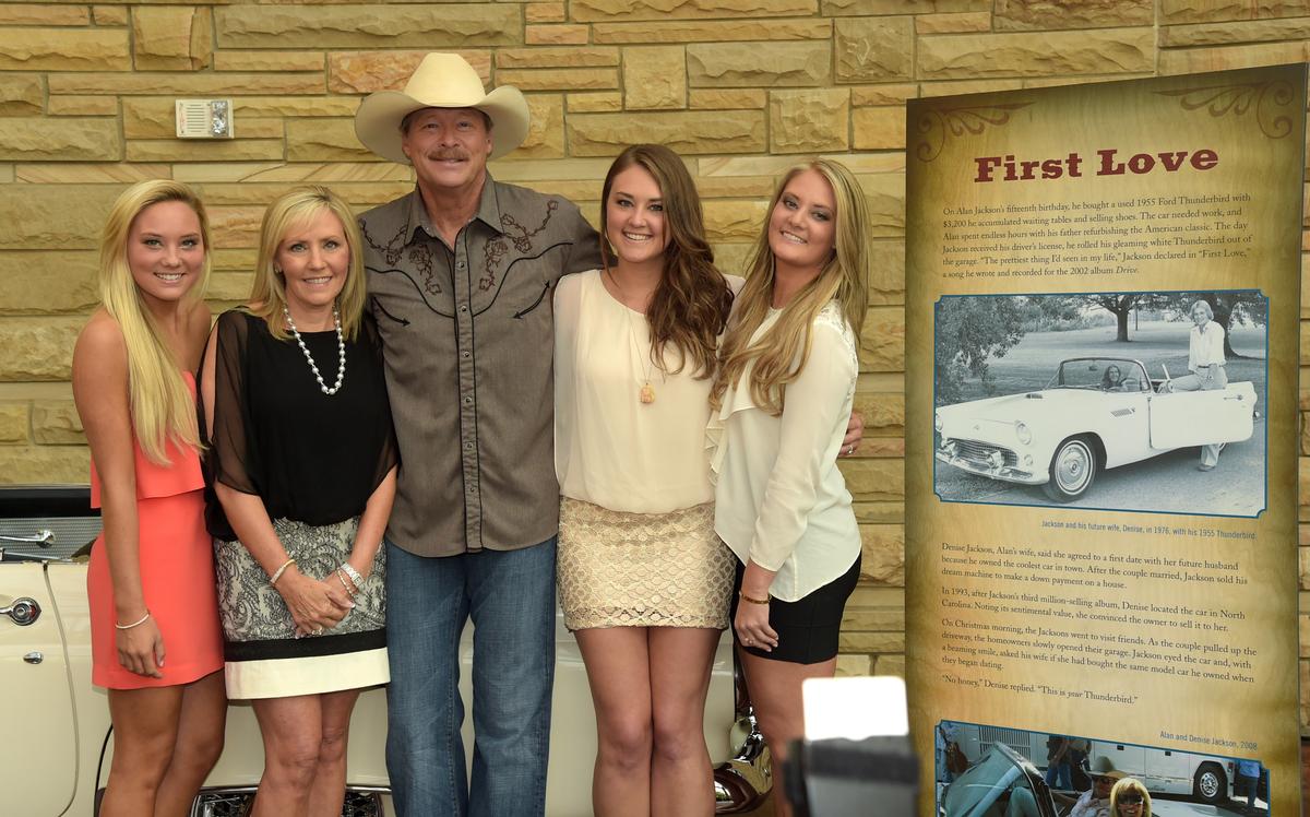(L-R) Dani, Denise, Alan, Ali, and Mattie Jackson pose by Jackson's 1955 Ford Thunderbird at the opening of his "Alan Jackson: 25 Years of Keepin' It Country" exhibit at the at Country Music Hall of Fame and Museum on Aug. 27, 2014 in Nashville. (Rick Diamond/Getty Images)