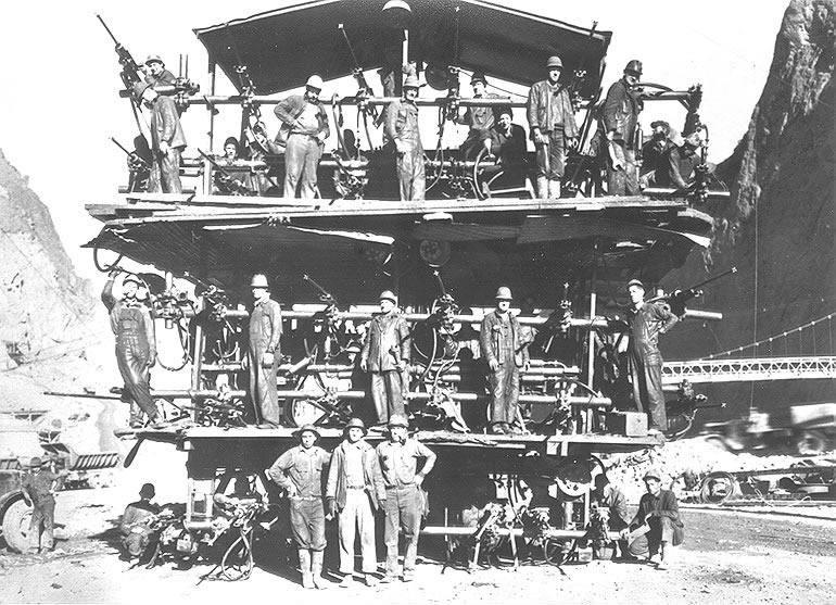 Workers on a "Jumbo Rig," used for drilling the Hoover Dam's tunnels. Bureau of Reclamation. (Public Domain)