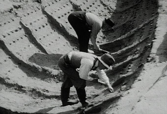 A 1939 photo still of of the Sutton Hoo ship-burial excavation by Harold John Phillips, brother of British archaeologist Charles Phillips. (Public Domain)