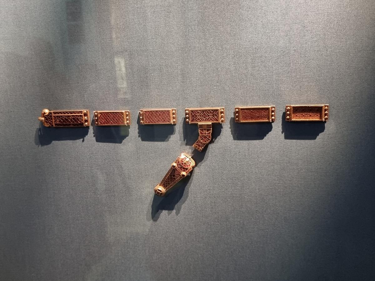 A rectangular gold harness-mount, which consists of an upper plate fixed to a lower plate by three rivets at each end, was found at the Sutton Hoo burial site. (David Winn-Morgan/Shutterstock)