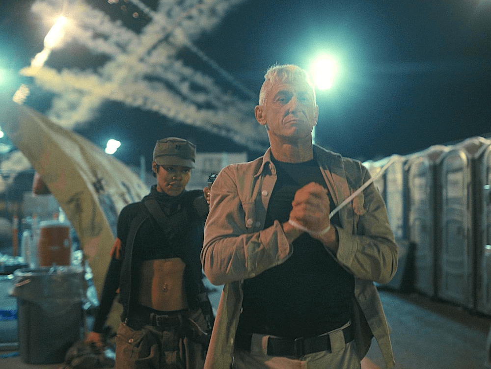 Col. Steven J. Lockjaw (Sean Penn) is held at gunpoint by Perfidia Beverly Hills (Teyana Taylor), in "One Battle After Another." (Warner Bros.)