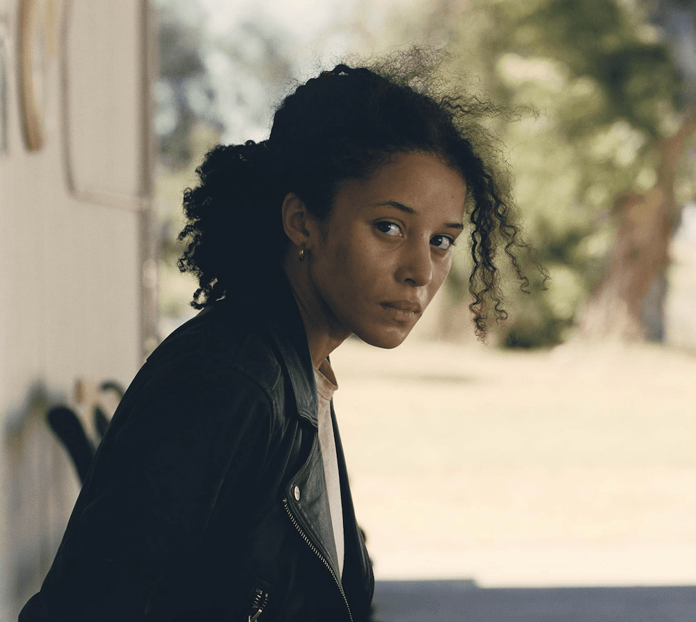 Willa (Chase Infiniti) looking to shed handcuffs and make a getaway, in "One Battle After Another." (Warner Bros.)