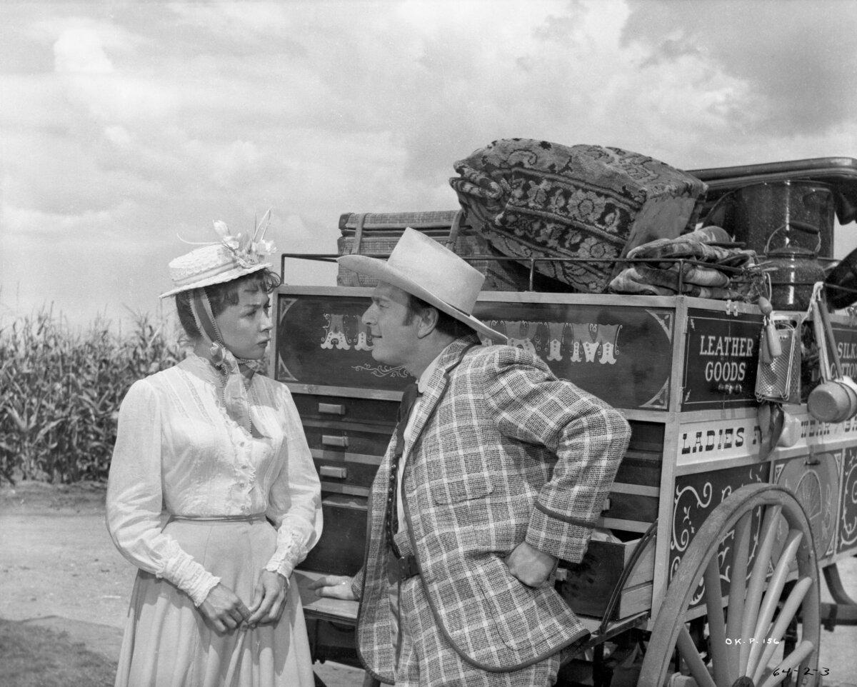 Ado Annie (Gloria Grahame) is quite taken with peddler Ali Hakim (Eddie Albert), in the musical "Oklahoma!" (RKO Radio Pictures/MovieStillsDB)