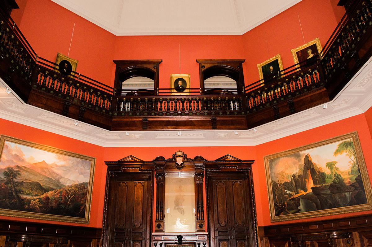 The rotunda, which features a 42-foot cove ceiling topped with a double skylight, is the focal point of the mansion's interior. LeGrand Lockwood displayed his collection of paintings and statuary—most notably, Bierstadt’s colossal Yosemite landscape—in this central, octagonal court. The bedroom suites are located off the second-story gallery that encircles the rotunda’s court. (<a href="https://www.sarahgroteart.com/" target="_blank" rel="nofollow noopener">Sarah Grote Photography</a>/Lockwood-Mathews Mansion Museum)