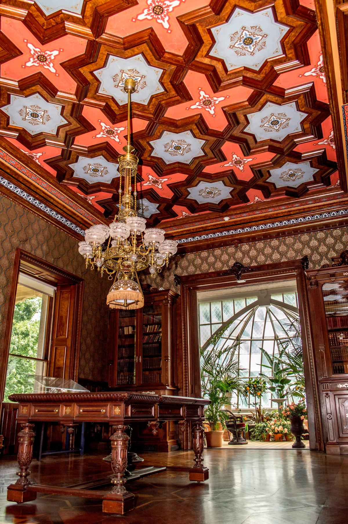 One of the most magnificent first-floor rooms, the library was designed and furnished by Léon Marcotte, one of New York City’s most noted interior decorators during the 1860s. The room boasts hand-carved black walnut door frames, bookcases, and coffered ceiling panels as well as parquet floors made from five types of wood. The library’s original embossed wallpaper was reproduced by the French fabric manufacturer Scalamandre. (<a href="https://www.sarahgroteart.com/" target="_blank" rel="nofollow noopener">Sarah Grote Photography</a>/Lockwood-Mathews Mansion Museum)