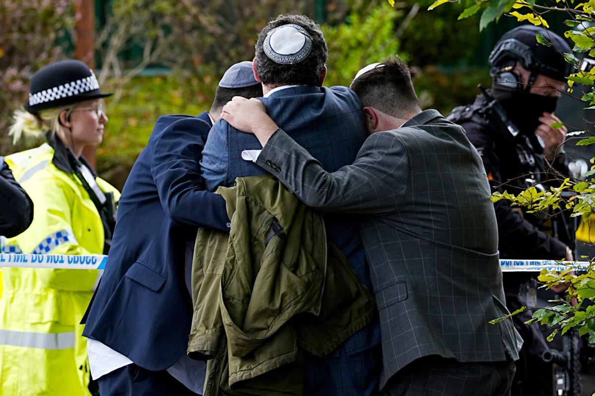 Members of the Jewish community comfort each other in the wake of a terrorist attack at the Heaton Park Hebrew Congregation synagogue in Crumpsall, Manchester, England, on Oct. 2, 2025. (Peter Byrne/PA via AP)