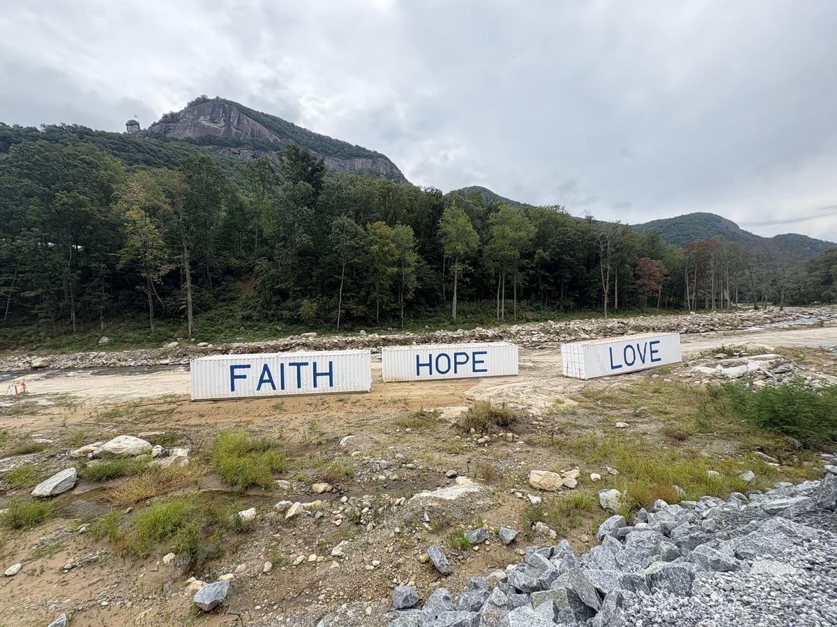 Shipping containers adorn an empty riverbed where many of the historic buildings of Chimney Rock, N.C., once stood. (Deena Bouknight)
