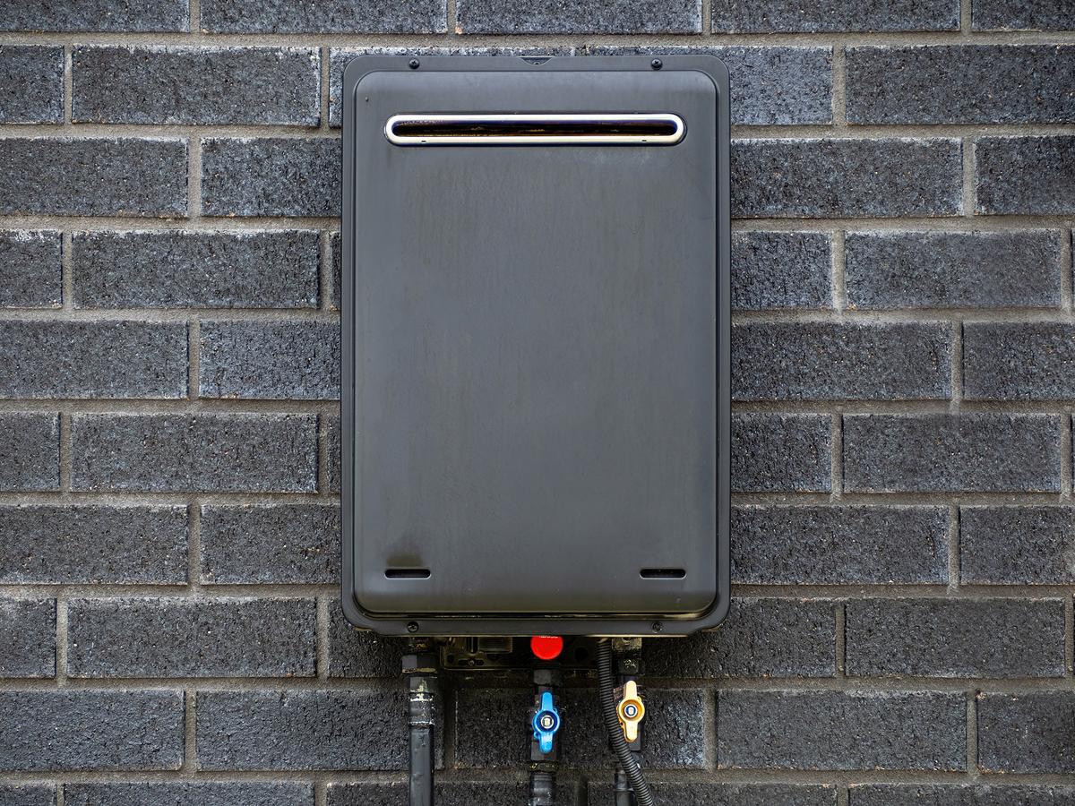 Tankless systems heat water on demand, saving space and reducing standby energy loss compared with conventional tanks. (Emagnetic/Shutterstock)