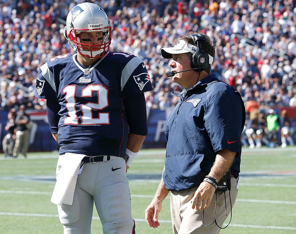Quarterback Tom Brady (L) confers with coach Bill Belichick of the New England Patriots during a game with the Tampa Bay Buccaneers in 2013. (Jim Rogash/Getty Images)