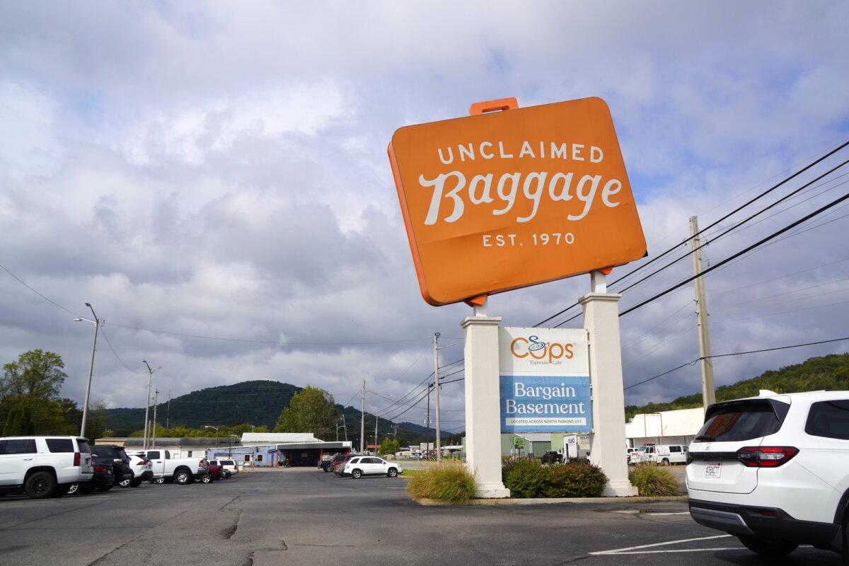 A big orange-and-white sign welcomes shoppers from around the world at Unclaimed Baggage in Scottsboro, Ala., on Oct. 8, 2025. (Allan Stein/The Epoch Times)