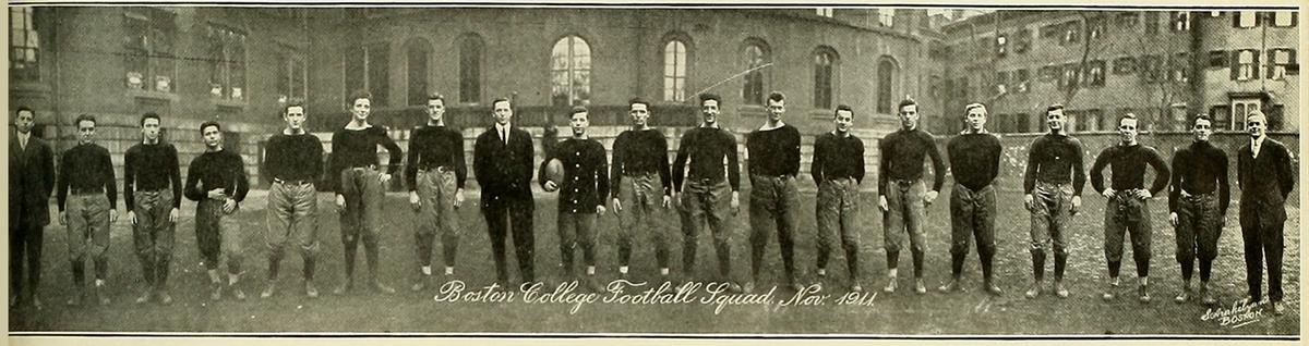 Boston College football squad, photographed in November 1911, from "Sub Turri: The Yearbook of Boston College" (Vol. 1), published by the senior class in June 1913. Internet Archive. (Public Domain)