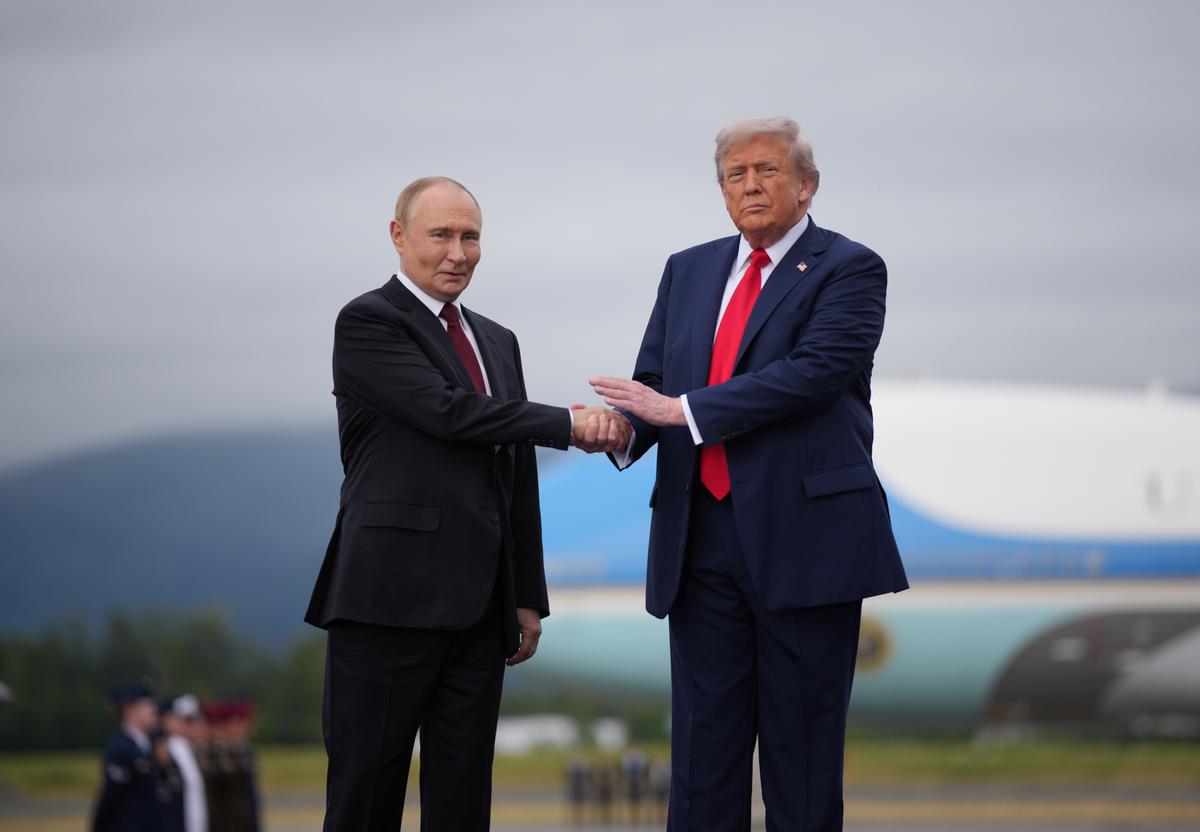 President Donald Trump (R) greets Russian President Vladimir Putin as he arrives at Joint Base Elmendorf-Richardson in Anchorage, Alaska, on August 15, 2025. (Photo by Andrew Harnik/Getty Images)