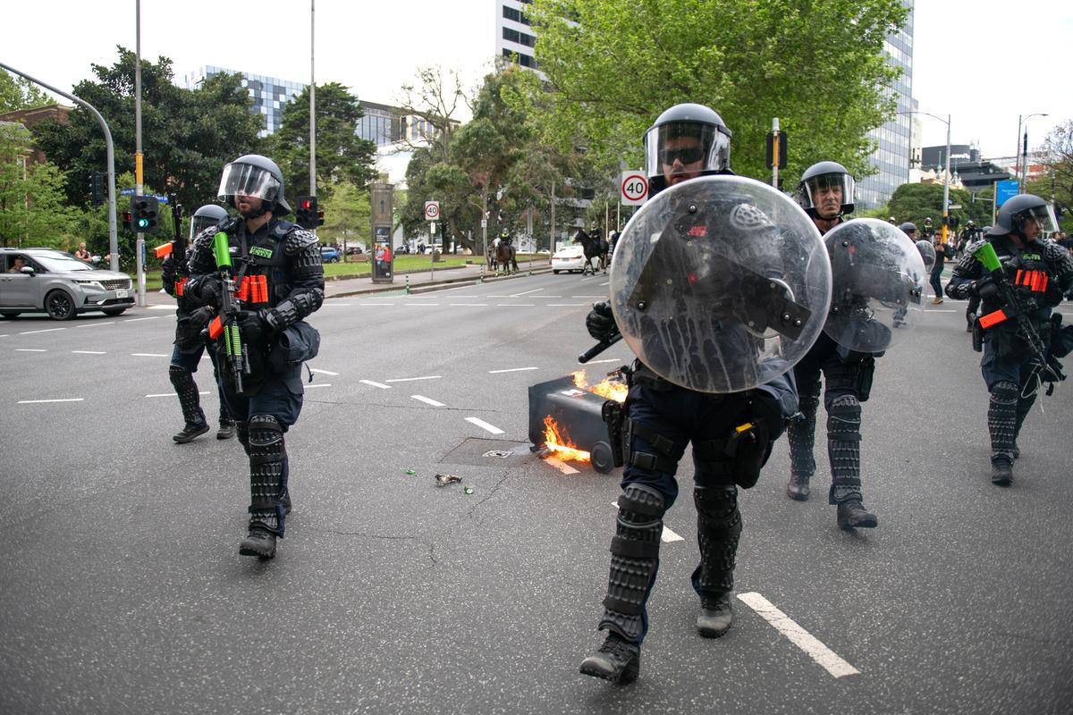Riot police confront violent, left-wing agitators who joined a counter protest against the "March for Australia" rally against current immigration policy in Melbourne, Australia on Oct. 19, 2025. (AAP Image/Jay Kogler)
