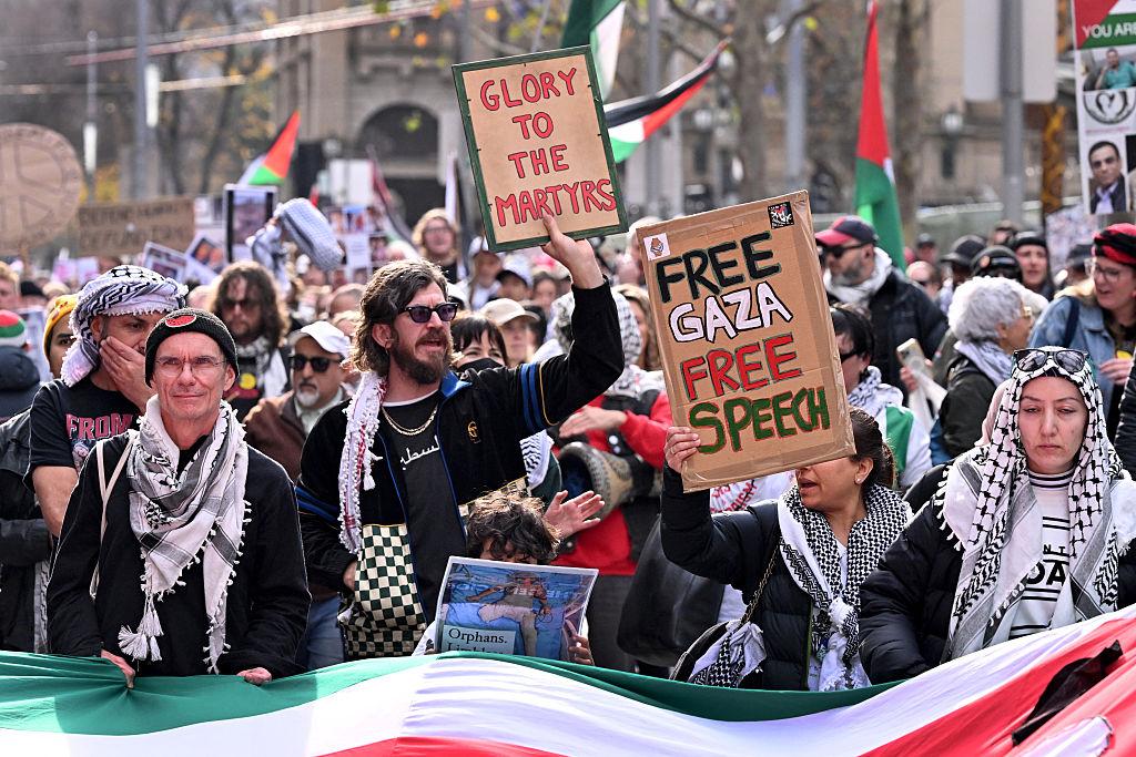 People hold placards and wave flags during a pro-Palestinian march in Melbourne, Australia, on July 6, 2025. (William West/AFP via Getty Images)