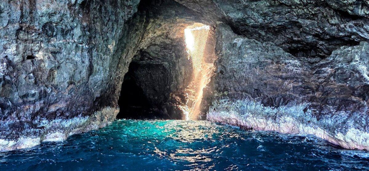 Sunlight hits a waterfall in a grotto along the Na Pali coast of Kaua'i, Hawaii. (Jim Farber)